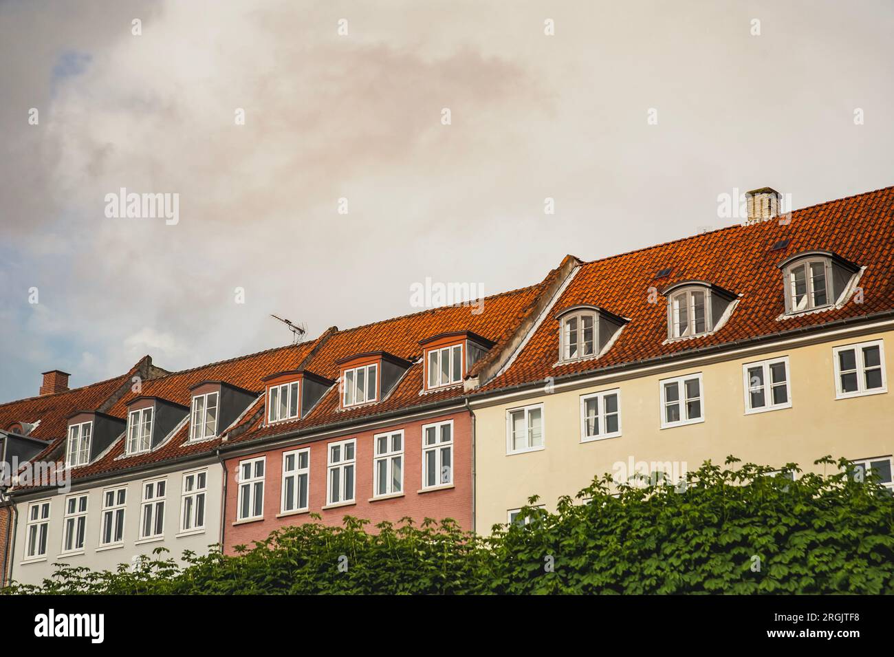 Danish neat architecture with 3 coloured buildings in a row, Copenhagen. Three houses lined up in show a Scandinavian urban design or architecture Stock Photo