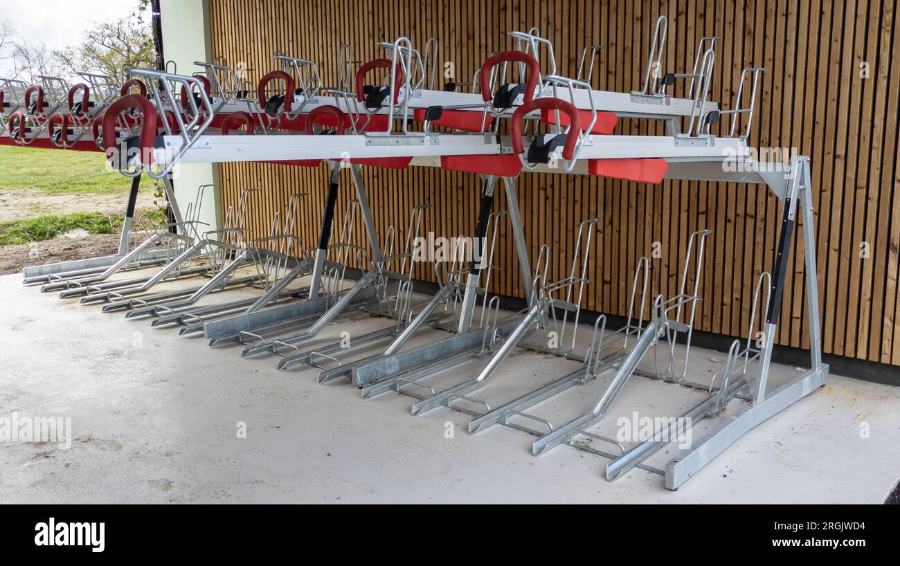 modern bike parking in city park space for multiple bikes bicycles in new urban transport in town Stock Photo