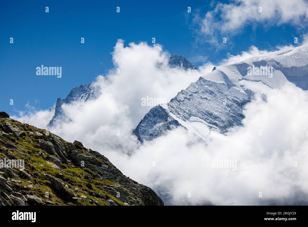 cloud and snow covered peaks of Grand Cornier and Dent Blanche in the