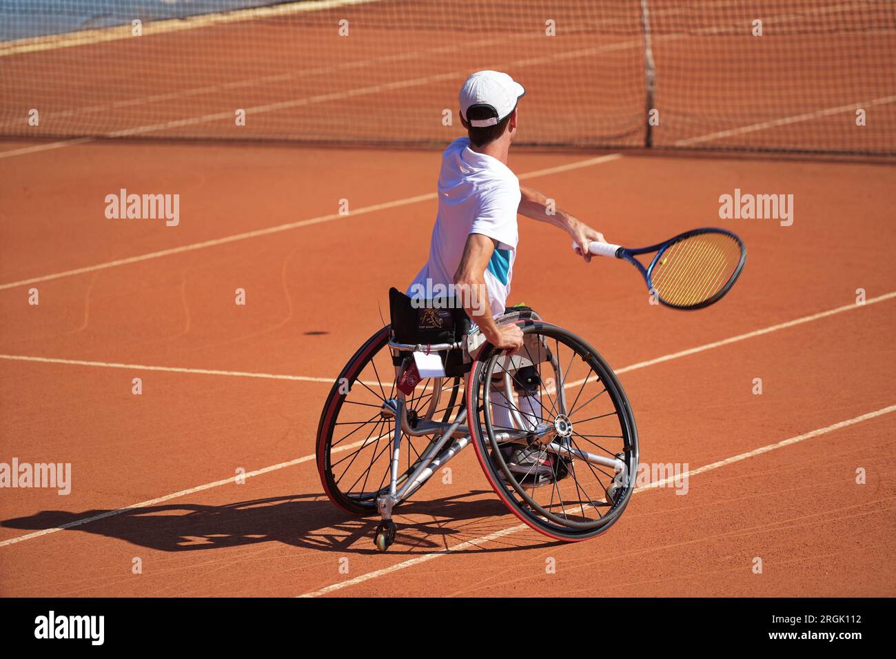 Man practices tennis in a wheelchair on a clay court. Wheelchair tennis Stock Photo Alamy