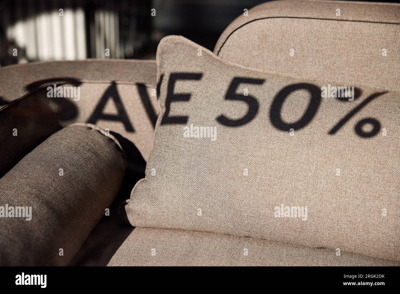 Sale – "Save 50%", shadows on sofa in shop window Stock Photo
