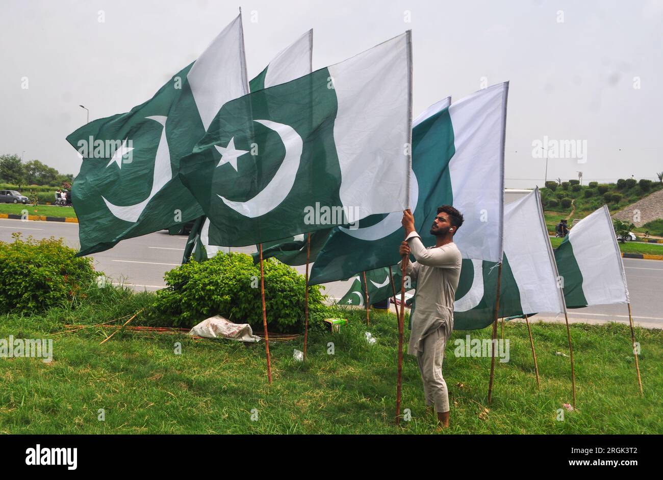 Islamabad, Pakistan. 10th Aug, 2023. A shopkeeper displays the national flag while waiting for customers in Islamabad, ahead of Pakistan's Independence Day celebrations. The nation will celebrate its 77th Independence Day on August 14. (Photo by Raja Imran Bahadar/Pacific Press) Credit: Pacific Press Media Production Corp./Alamy Live News Stock Photo