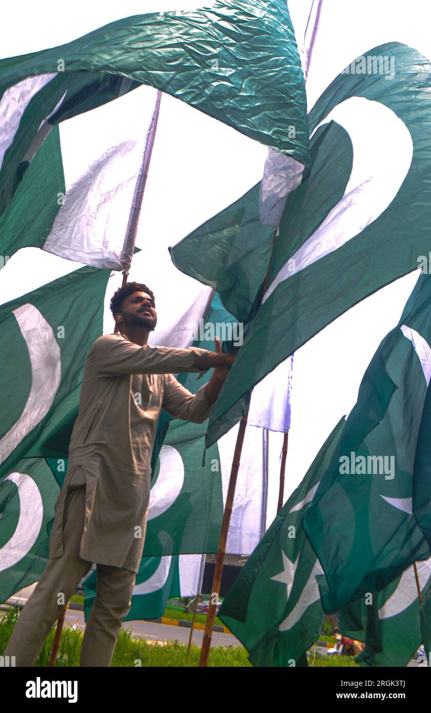 Islamabad, Pakistan. 10th Aug, 2023. A shopkeeper displays the national flag while waiting for customers in Islamabad, ahead of Pakistan's Independence Day celebrations. The nation will celebrate its 77th Independence Day on August 14. (Photo by Raja Imran Bahadar/Pacific Press) Credit: Pacific Press Media Production Corp./Alamy Live News Stock Photo