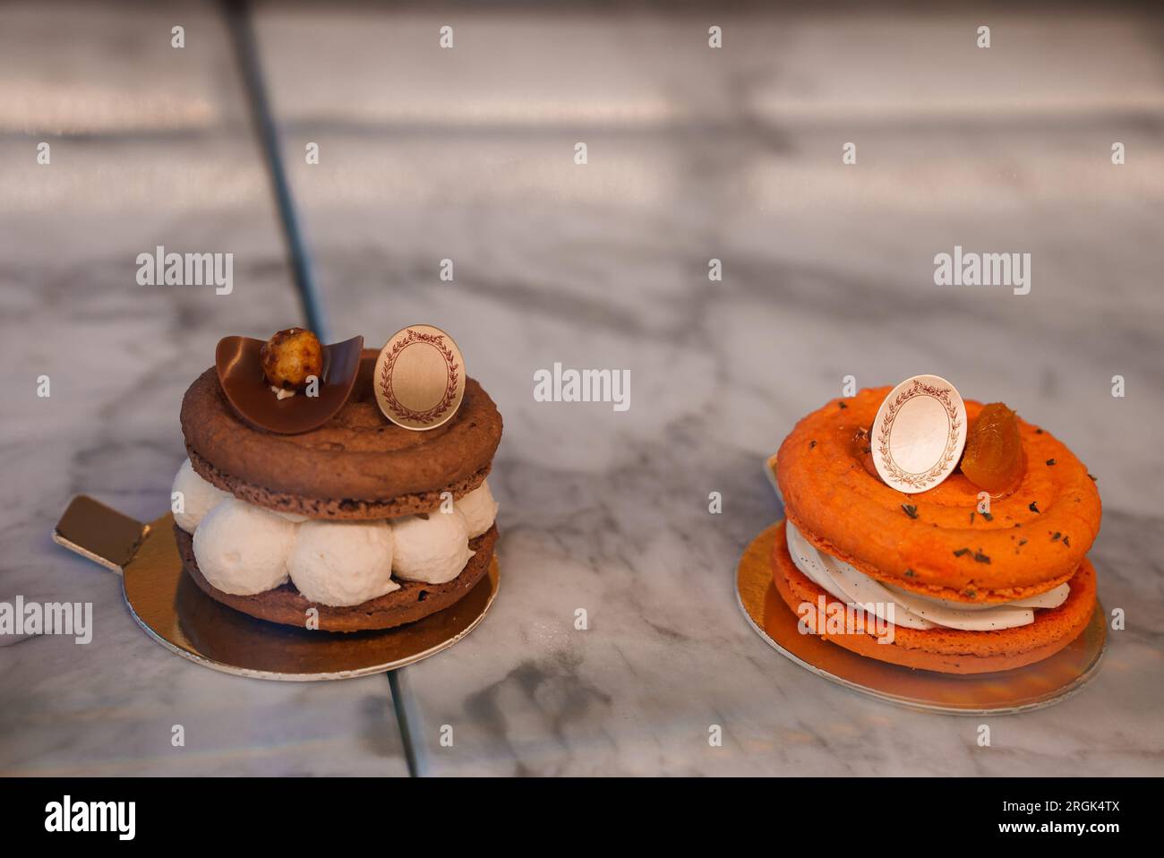Orange and White Macarons on Marble Table Stock Photo