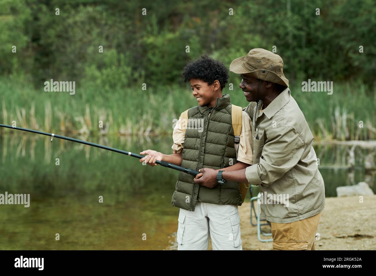 dad helps son reel in fish Cool Fishing Gift Father's Day Fisherman SVG PNG Files creativeusarts First Time Fishing Experience with