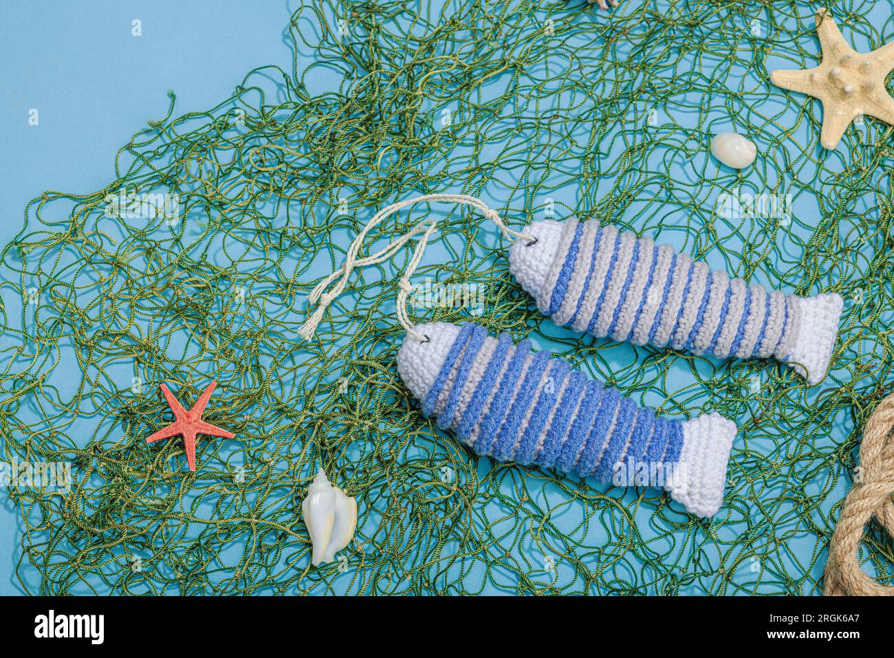 Handmade marine concept. Crocheted sardine fishes, nautical style