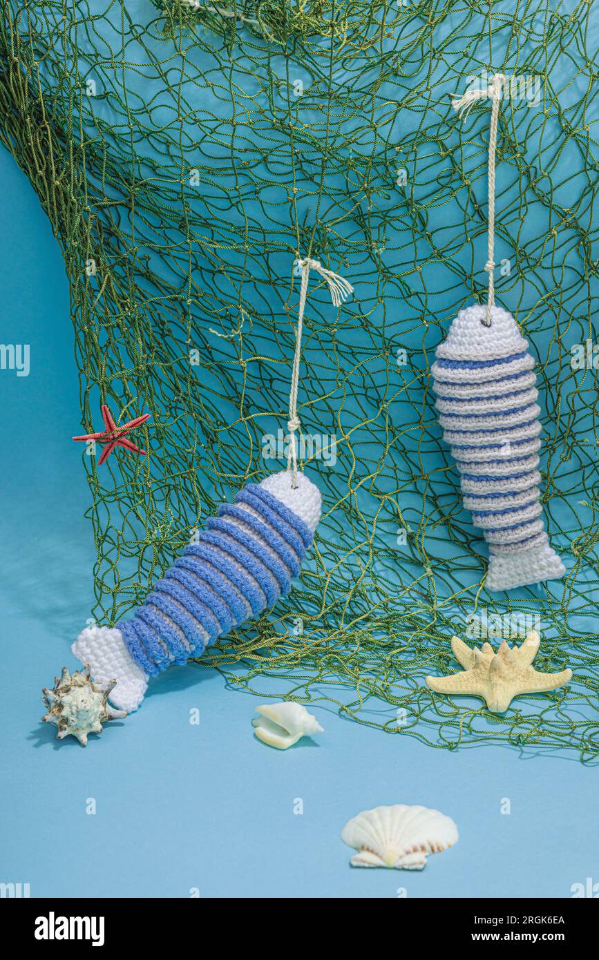 Handmade marine concept. Crocheted sardine fishes, nautical style