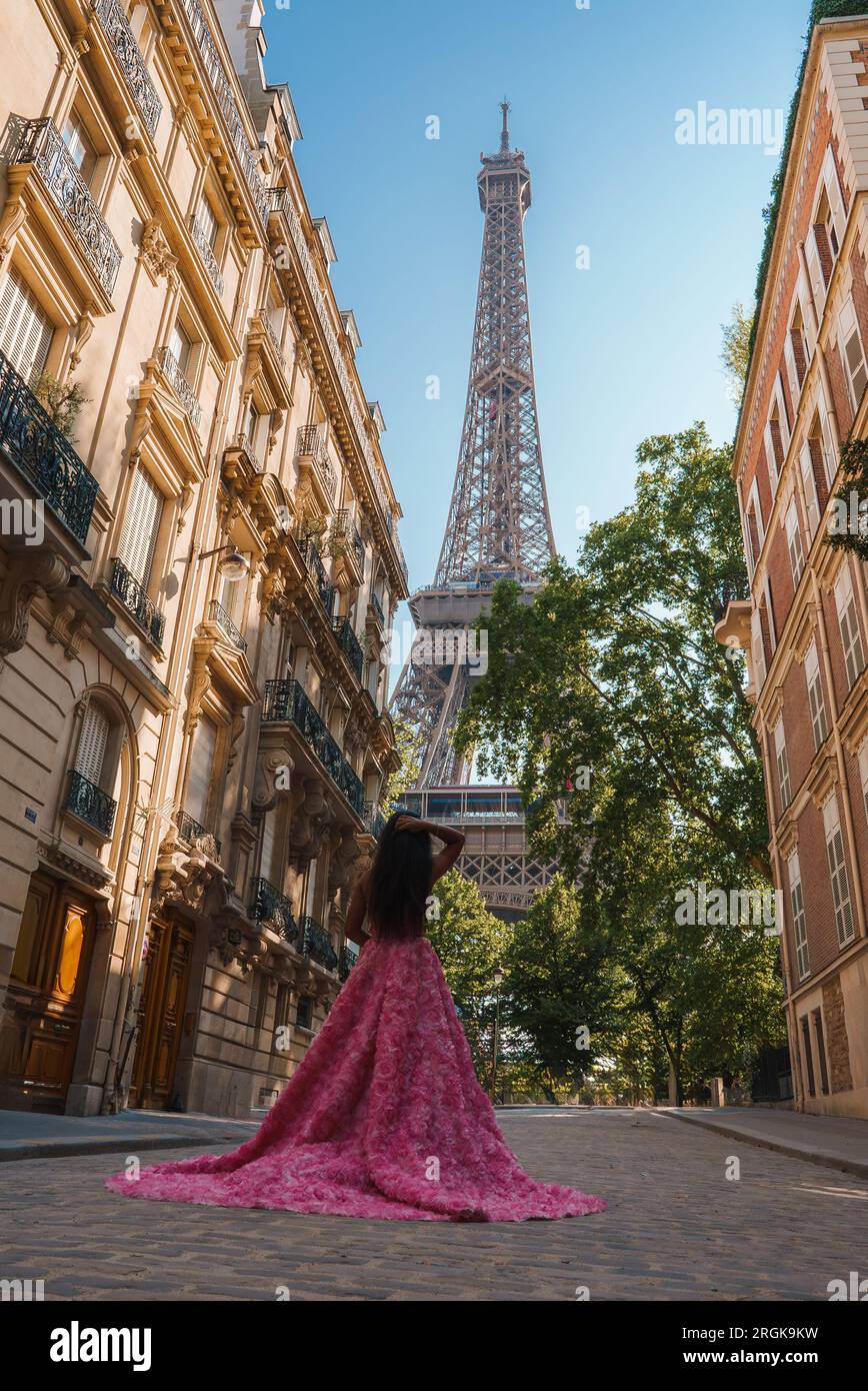 Joyful Woman in Pink at the Eiffel Tower Stock Photo
