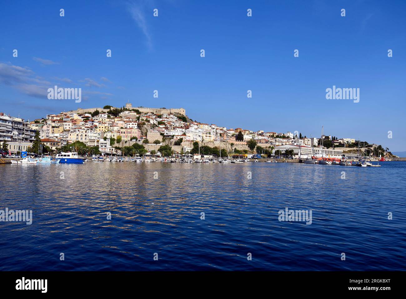 Kavala, Greece - June 13, 2023: Panoramic view of the city on the aegean sea with colorful houses, port, city walls and castle Stock Photo