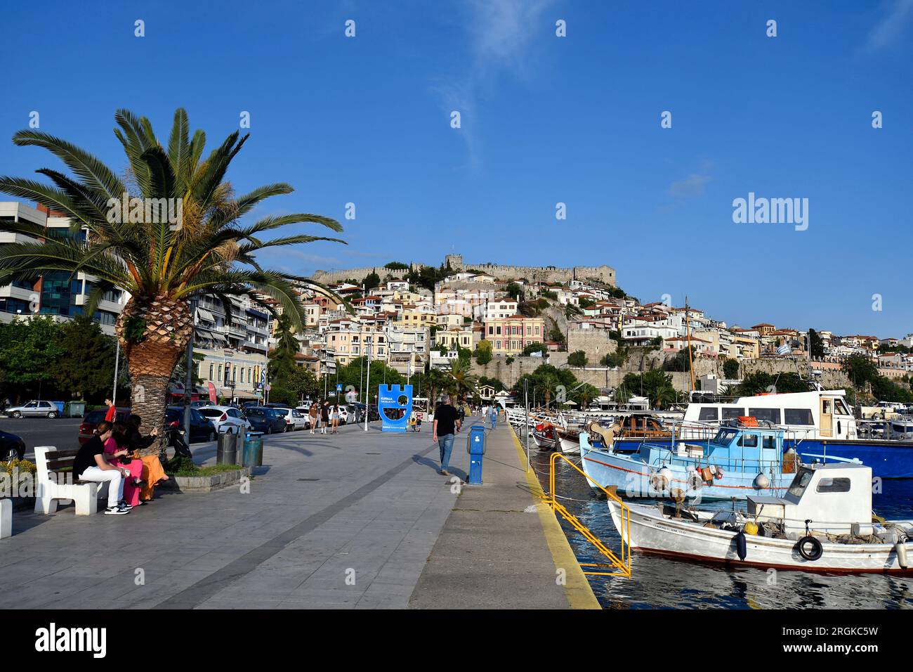 Kavala, Greece - June 13, 2023: Panoramic view of the city on the Aegean Sea with colorful houses, port, city walls and medieval castle Stock Photo