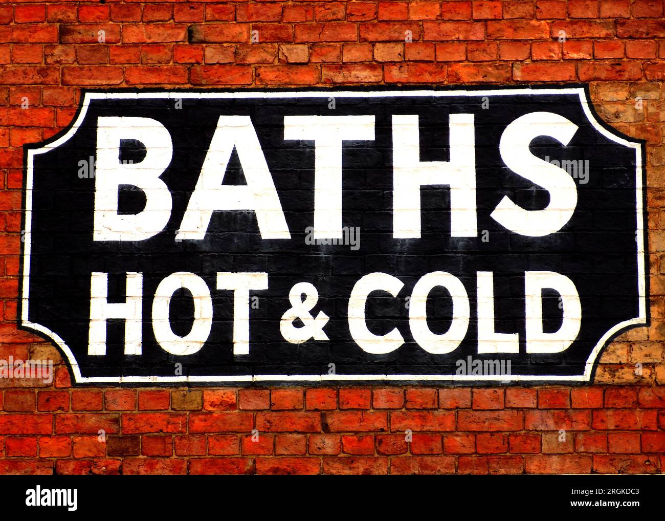 Ghost sign for baths painted on the brickwork of a Victorian building in Banbury, Oxfordshire, uk Stock Photo