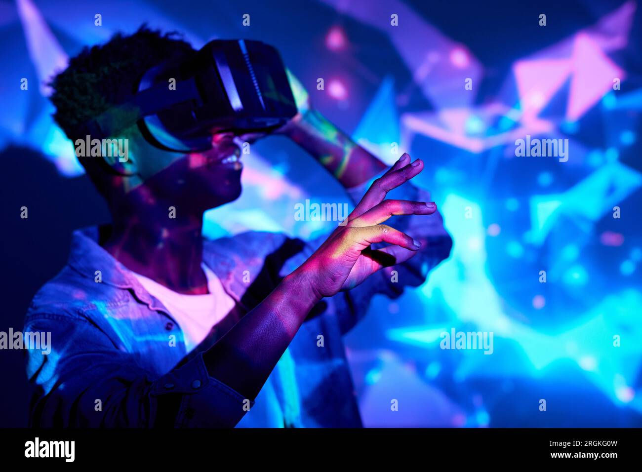 Glad African American male wearing VR goggles and experiencing virtual ...