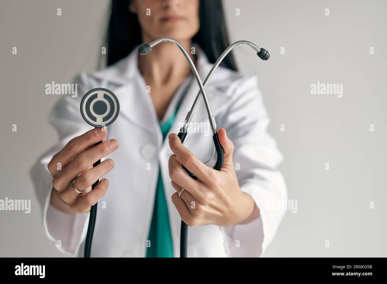Crop unrecognizable female doctor in medical uniform demonstrating ...
