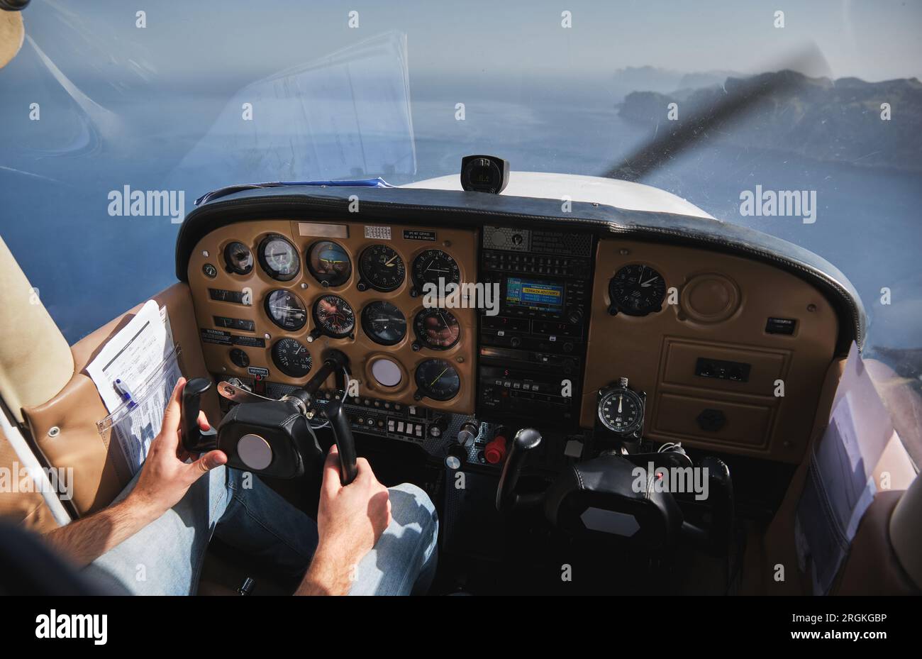 Crop anonymous male aviator steering airplane controls while flying ...