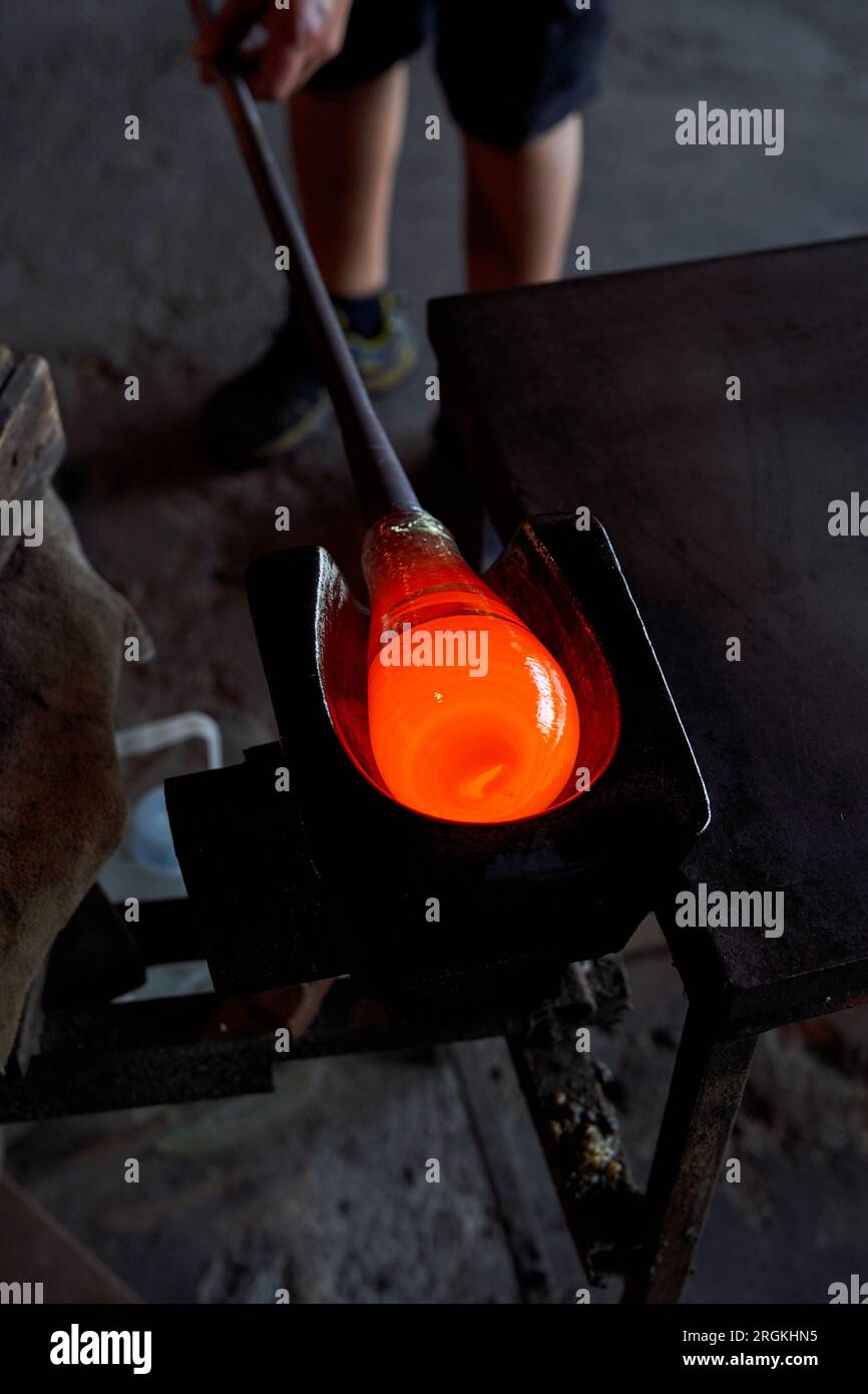 Unrecognizable professional male glassblower in process of making