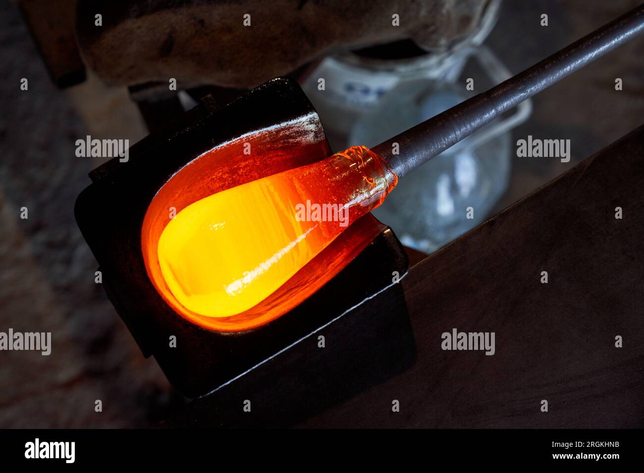 From above of heated liquid glass glob on tip of punty placed on