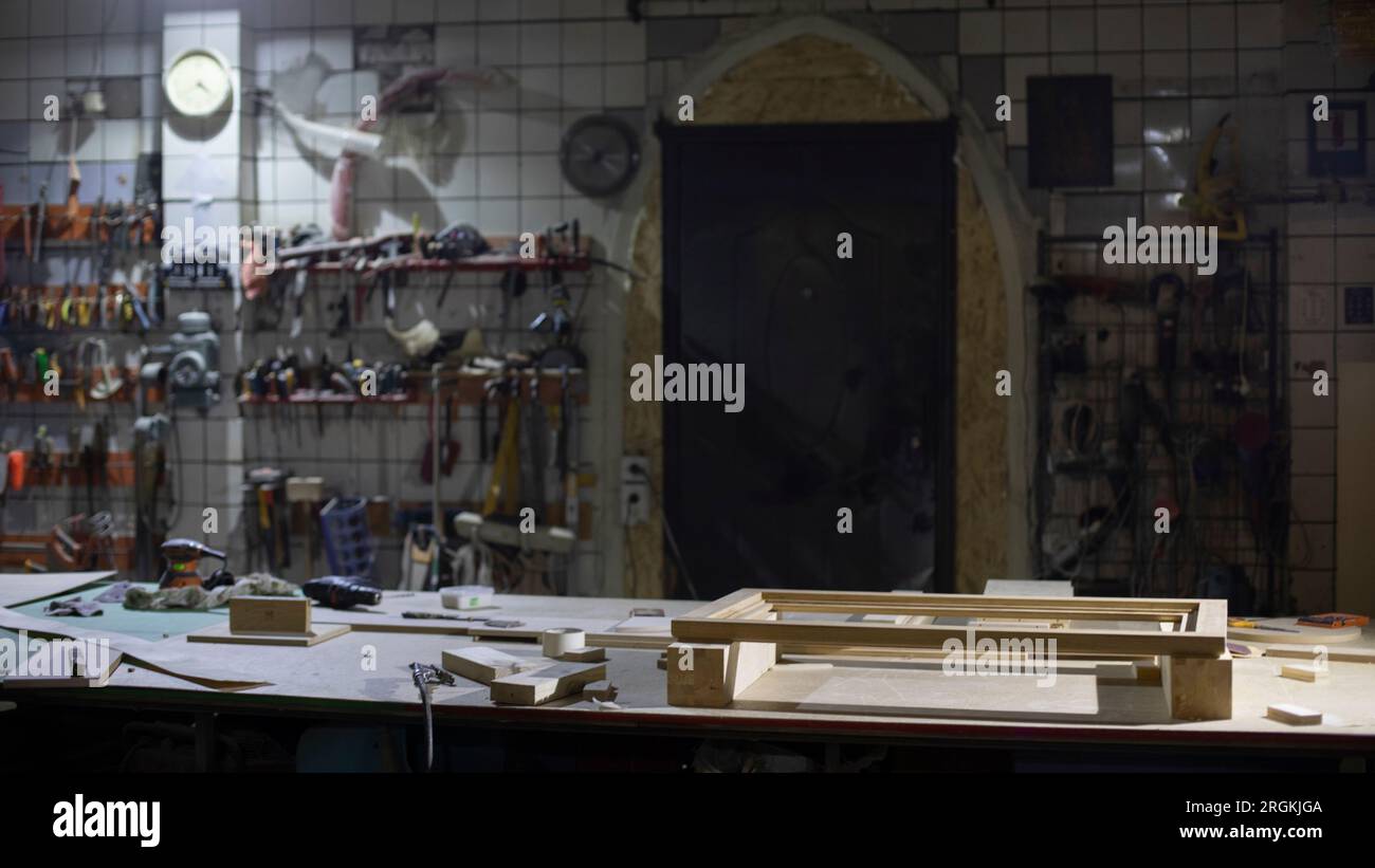 Items in garage. Workplace for creating structure. Production shop. Working tools on table. Stock Photo