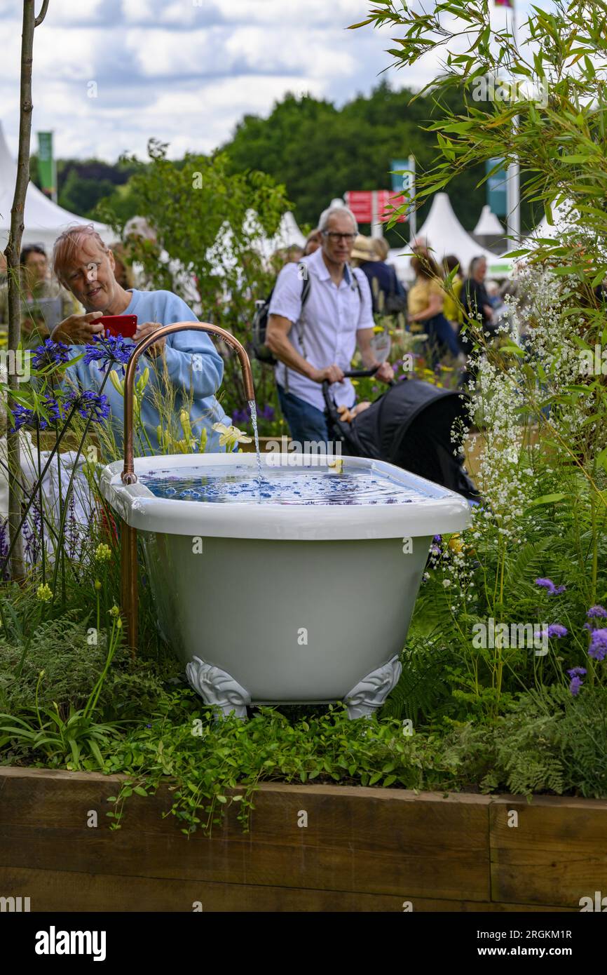 Person photographs water-feature bath (horticultural raised bed competition winner) - RHS Tatton Park Flower Show 2023 showground, Cheshire England UK Stock Photo