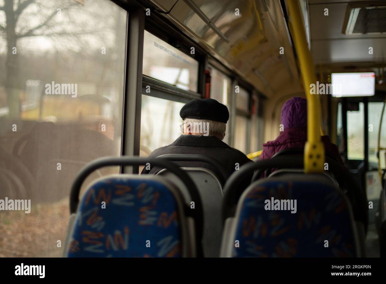 People on bus. Passengers sit on seats in transport. Inside public