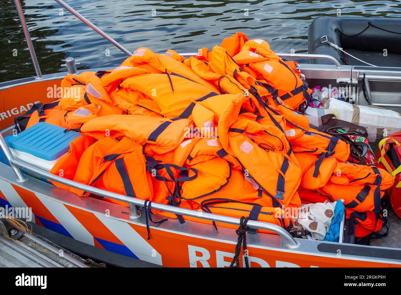 Pile of orange life jackets Stock Photo Alamy