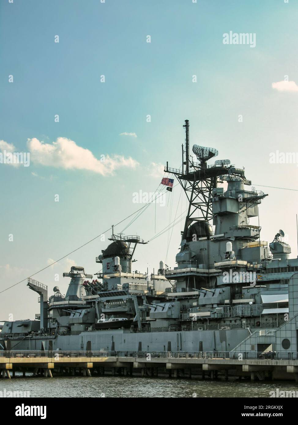 A large US battleship docked in the water in Camden, New Jersey Stock Photo