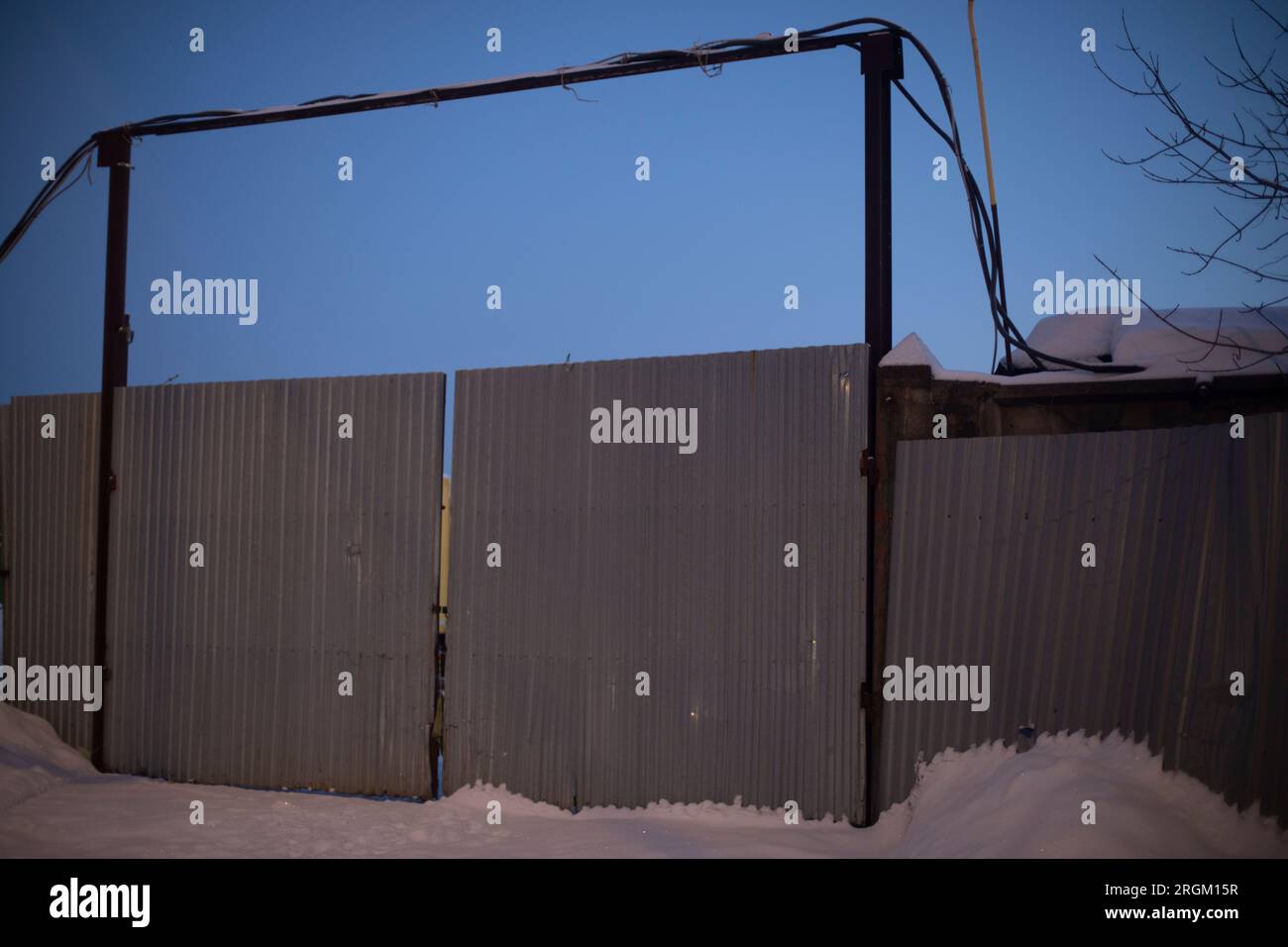 Gates in winter. Entrance to industrial zone. Steel gates. Fence around