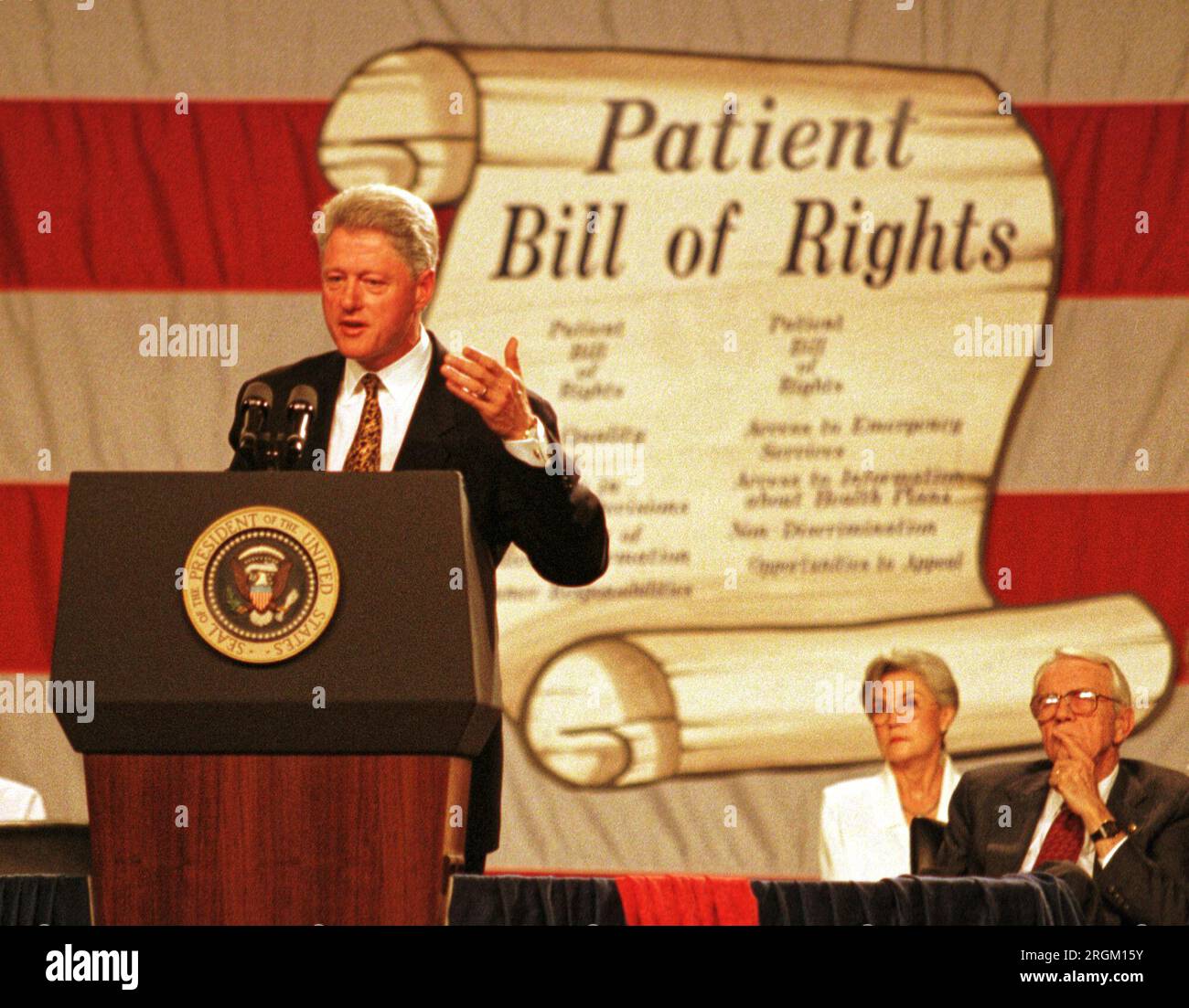 President Bill Clinton (left) promotes his proposed 'patients' bill of rights' legislation as retiring Kentucky Sen. Wendell H. Ford (right) and an unidentified woman look on during a visit to Kentucky on Monday, Aug. 10, 1998 at the Commonwealth Convention Center in Louisville, Jefferson County, KY, USA. Clinton attended a fundraiser luncheon for Democratic congressional candidate Scotty Baesler later in the day. (Apex MediaWire Photo by Billy Suratt) Stock Photo