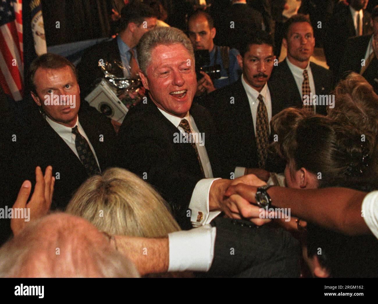 President Bill Clinton shakes hands with attendees while flanked by United States Secret Service agents after explaining his 'patients' bill of rights' initiative on Monday, Aug. 10, 1998 at the Commonwealth Convention Center in Louisville, Jefferson County, KY, USA. Clinton said the proposed legislation would help protect the confidentiality of people's personal medical details, among other things. (Apex MediaWire Photo by Billy Suratt) Stock Photo