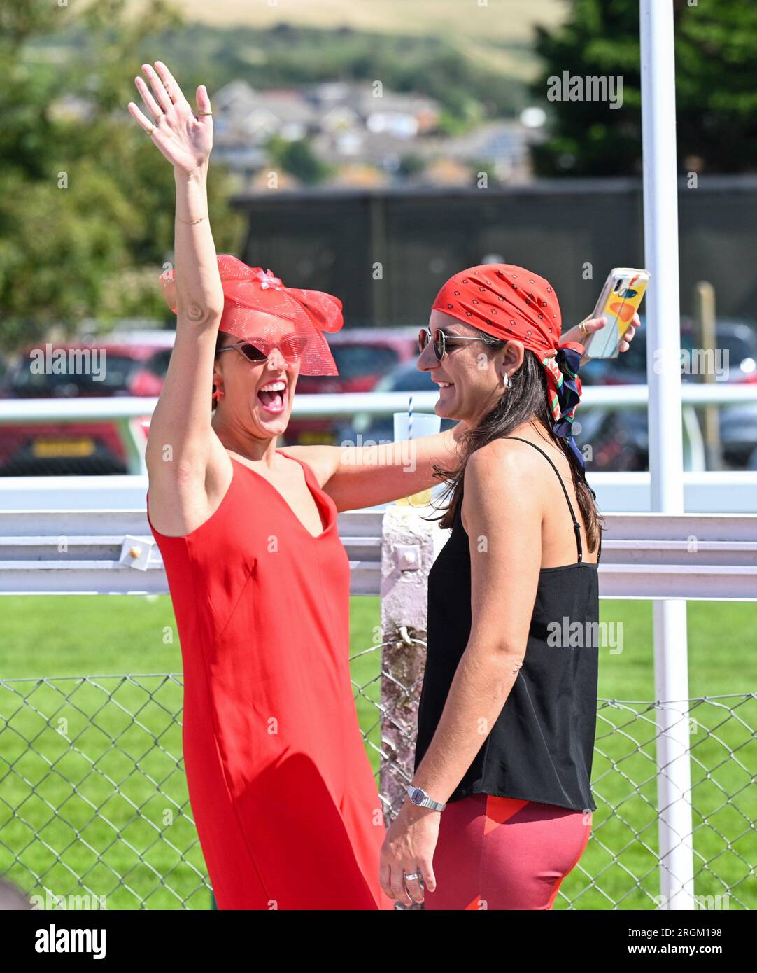 Brighton UK 10th August 2023 -  Racegoers enjoy a beautiful sunny day at Brighton Races Ladies Day  during the Star Sports 3 day Festival of Racing    : Credit Simon Dack / Alamy Live News Stock Photo