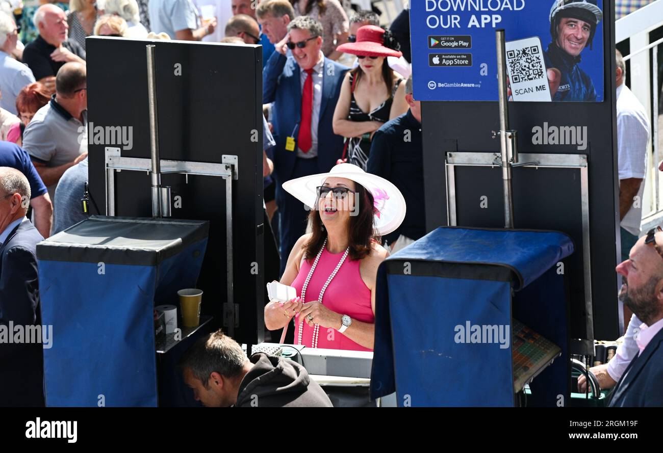 Brighton UK 10th August 2023 -  Racegoers enjoy a beautiful sunny day at Brighton Races Ladies Day  during the Star Sports 3 day Festival of Racing    : Credit Simon Dack / Alamy Live News Stock Photo