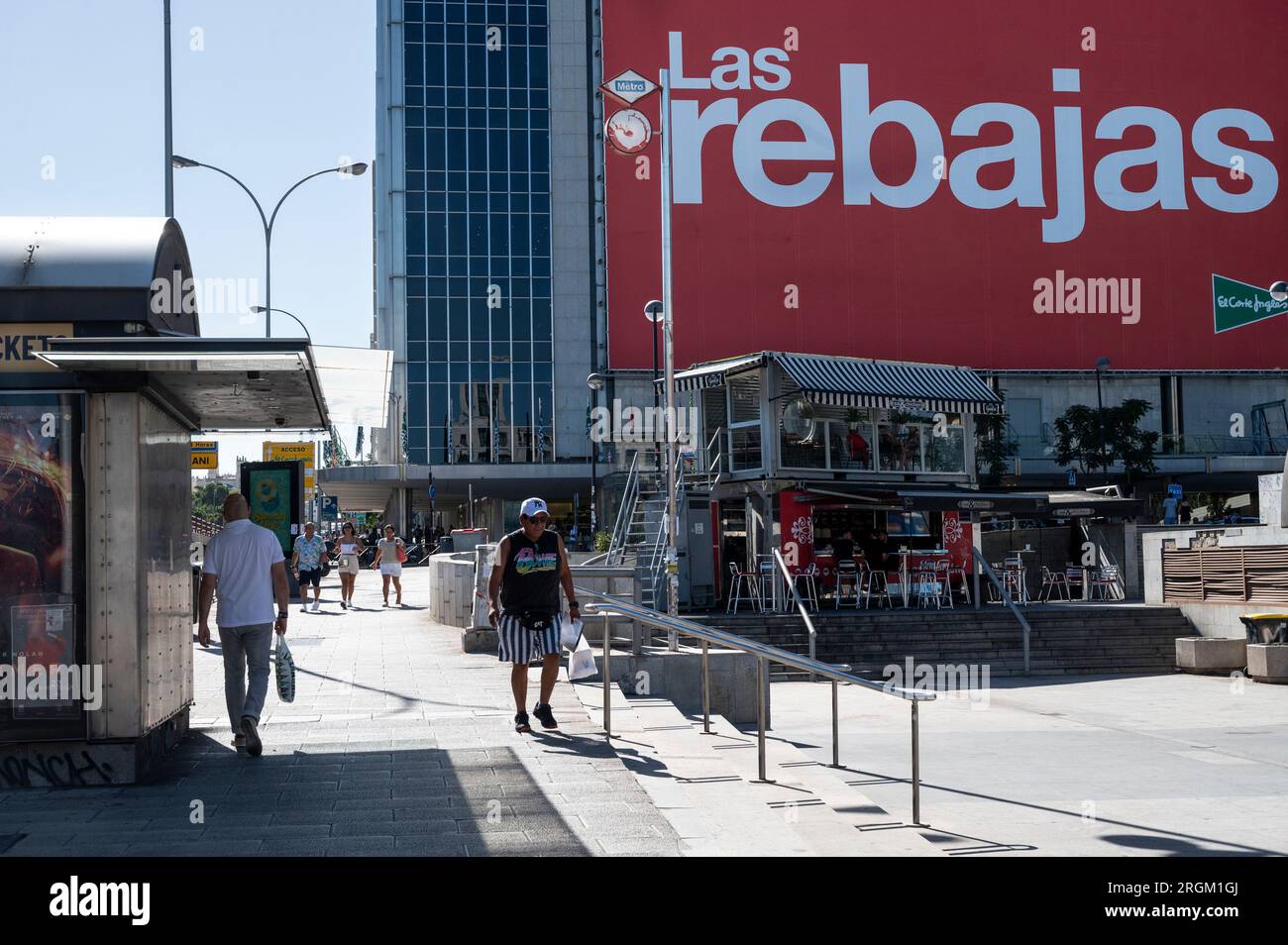 Madrid, Spain. 07th Aug, 2023. Pedestrians and shoppers are seen outside  the Spanish biggest department store El Corte Ingles as a large Summer sale  season (Rebajas in Spanish) billboard hangs in the