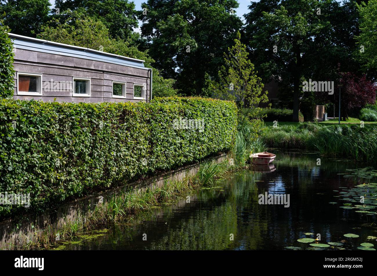 Wooden house and green creek as a background, Barendrecht, South Holland, The Netherlands Stock Photo