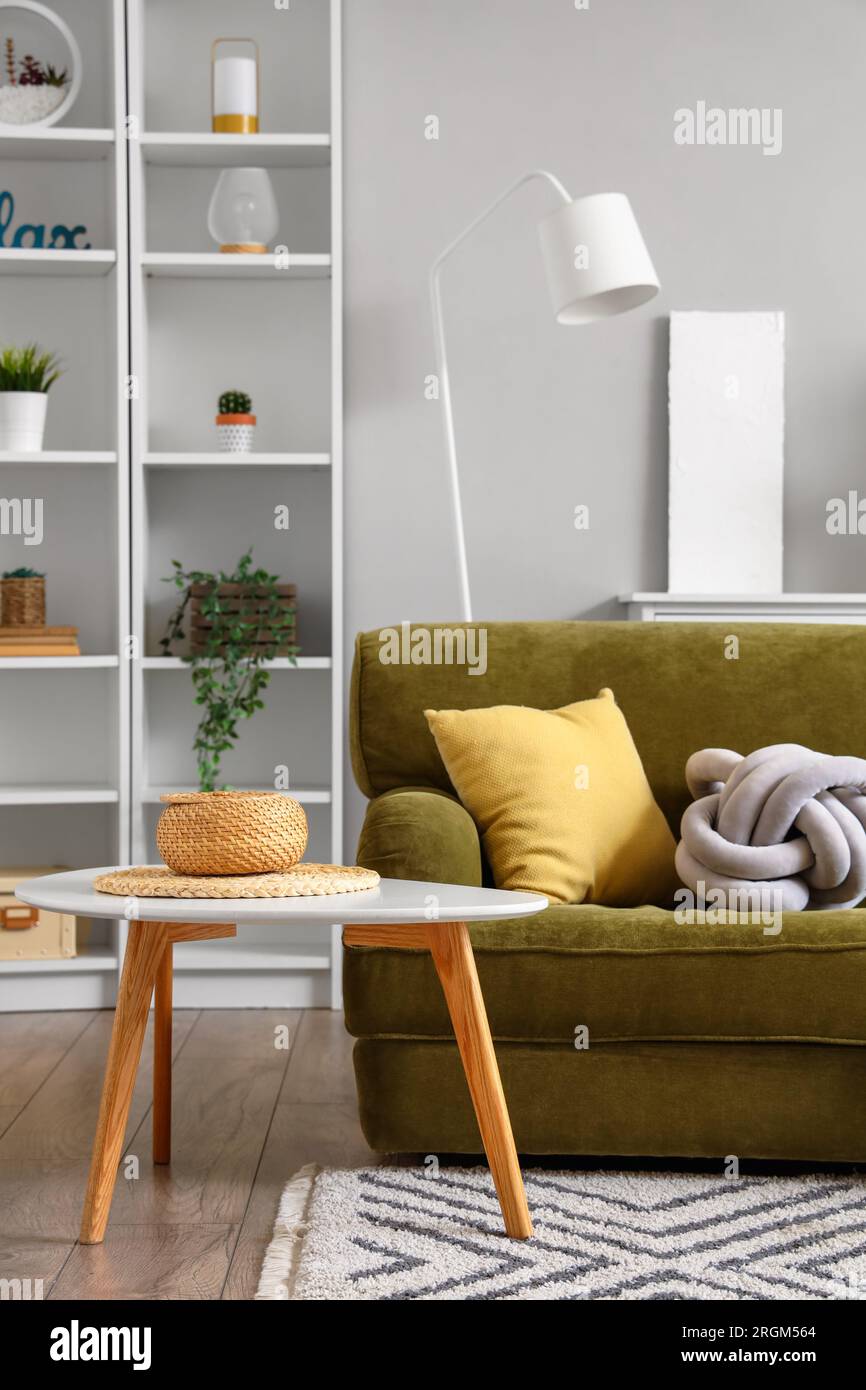 Interior of living room with cozy green sofa and coffee table Stock ...