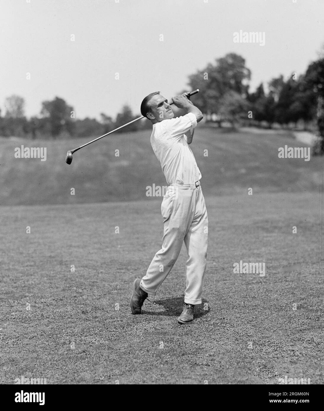 Golfer Eddie Frost hitting a golf ball ca. 1925 Stock Photo