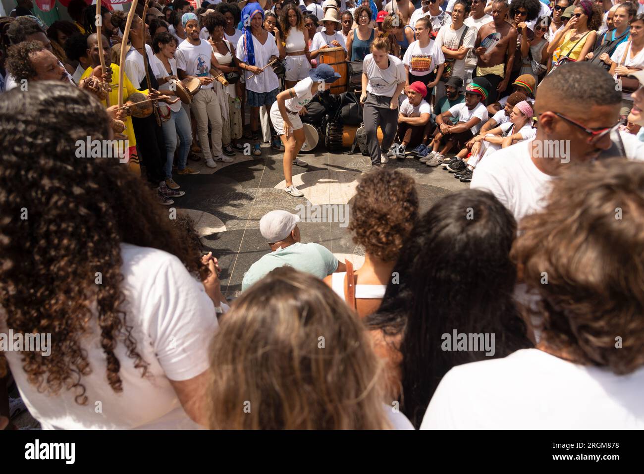 Salvador, Bahia, Brazil - February 02, 2023: Group of capoeiristas are seen performing during festivities for Yemanja on Rio Vermelho beach in Salvado Stock Photo