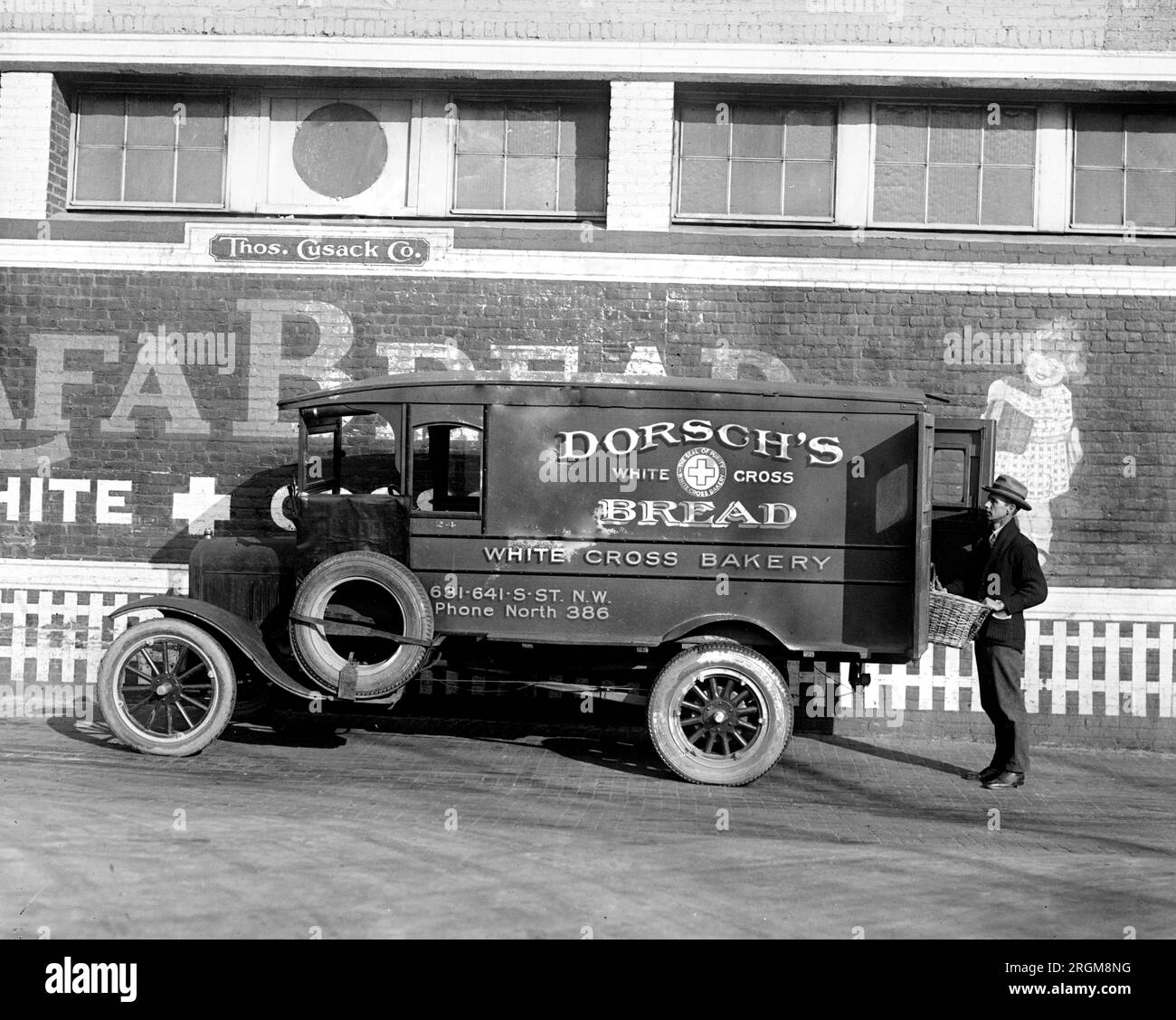 A man delivering bread from Dorsch's Bread Truck (Ford delivery truck) ca. 1926 Stock Photo