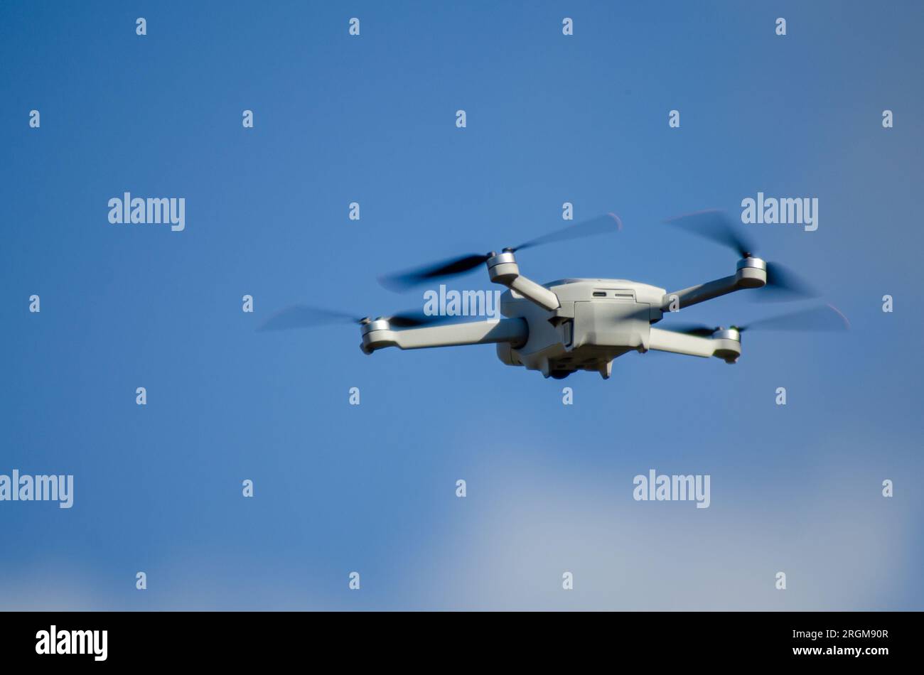 vigo, españa 07-31-2023 a DJI Mavic Mini 3 drone in flight, blue sky in the background. Stock Photo