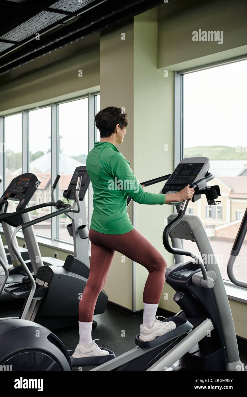 active senior, elderly woman in sportswear exercising in gym, using ...