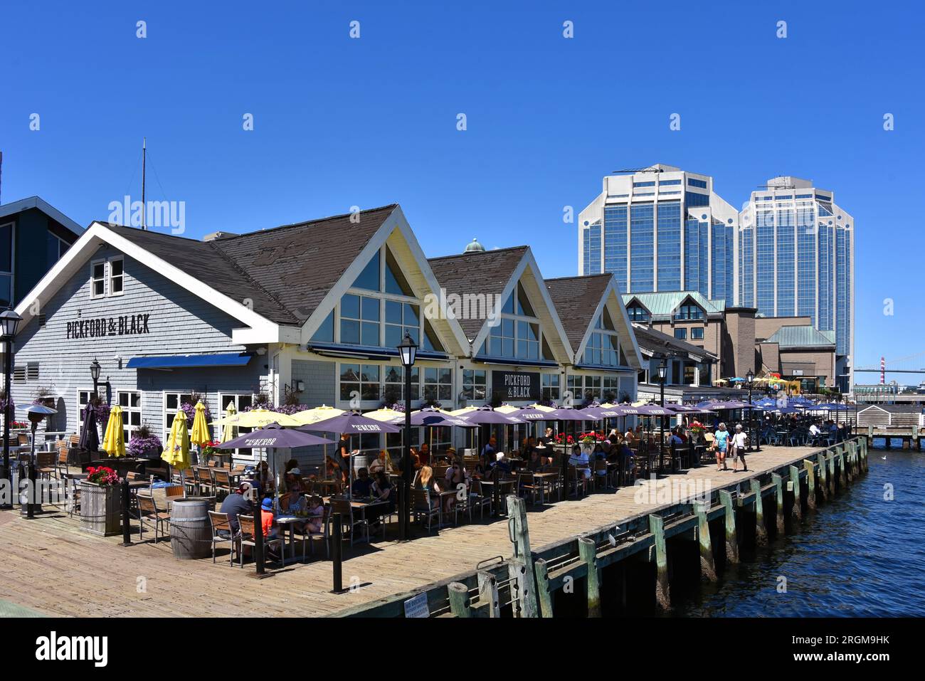 Halifax, Canada - August 2, 2023: People dining on the patio of Pitchford and Black, a restaurant on the Halifax Waterfront which is a tourist attract Stock Photo
