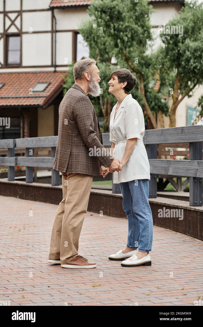 woman and bearded man holding hands, date, senior romance, happy