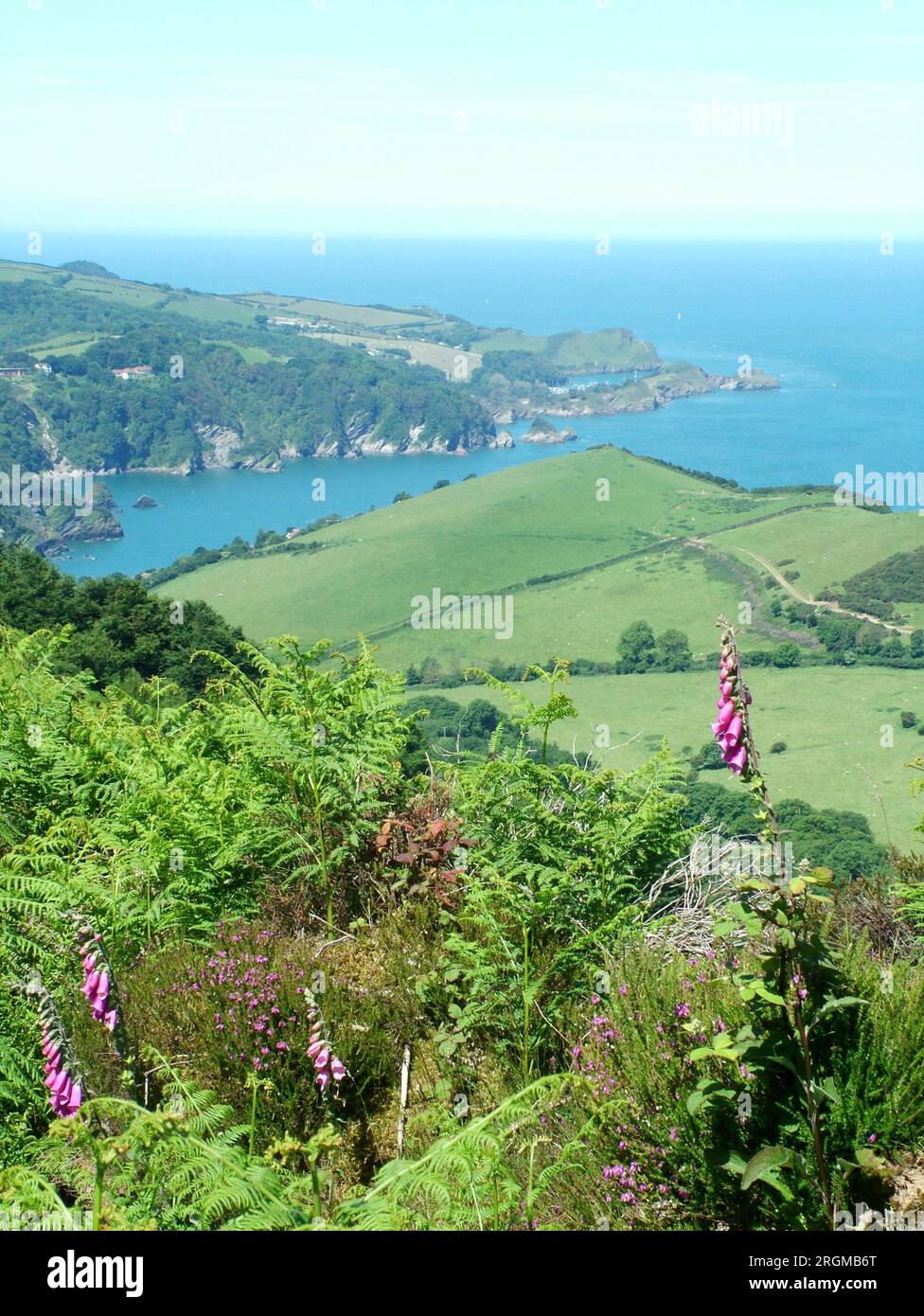 View from the top of Little Hangman hill looking west over Combe Martin bay towards Widmouth Head on the South West coast path on a bright summers da Stock Photo