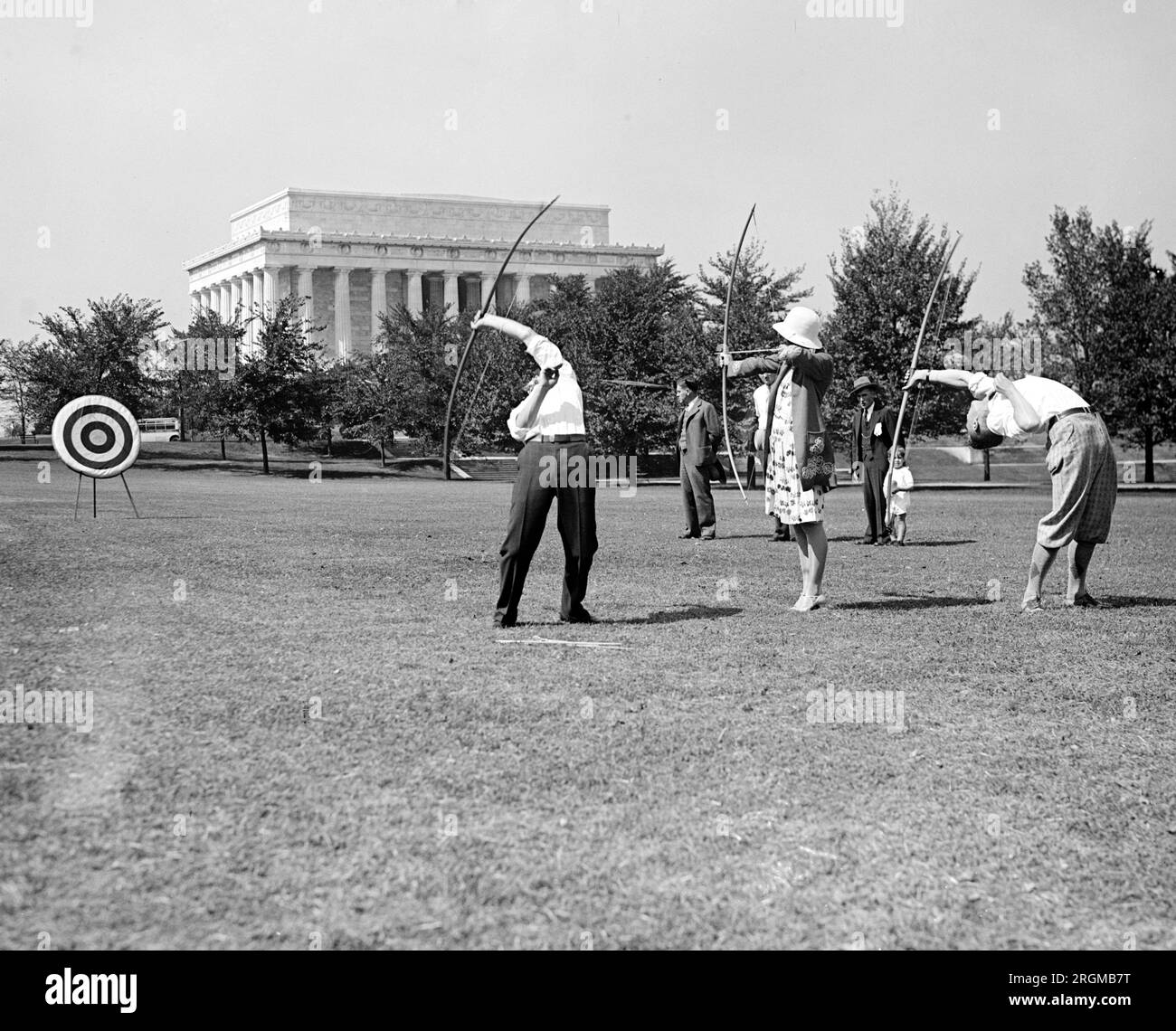 Vintage Archery: Archers trick shooting at a target ca. 1929 Stock Photo