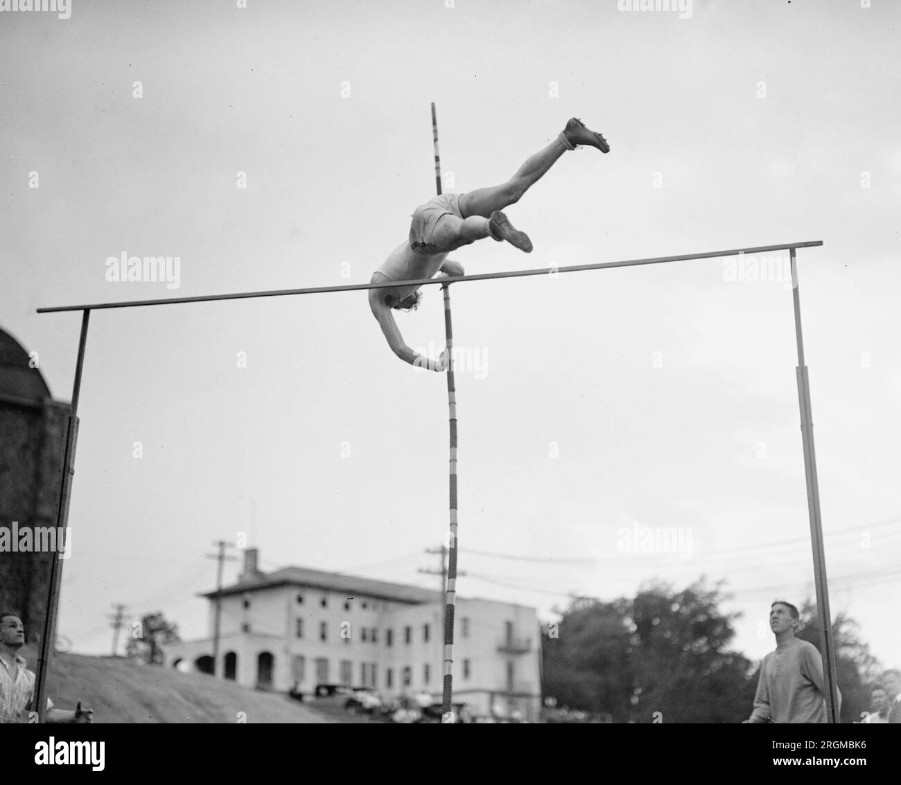 High jumper clearing the rail at a track meet ca. 1928 Stock Photo