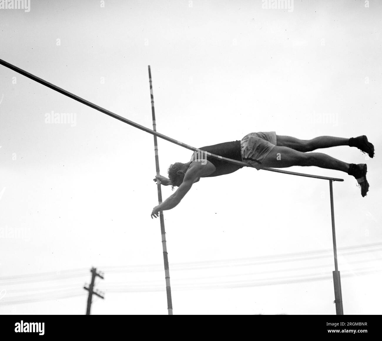 High jumper clearing the rail at a track meet ca. 1928 Stock Photo