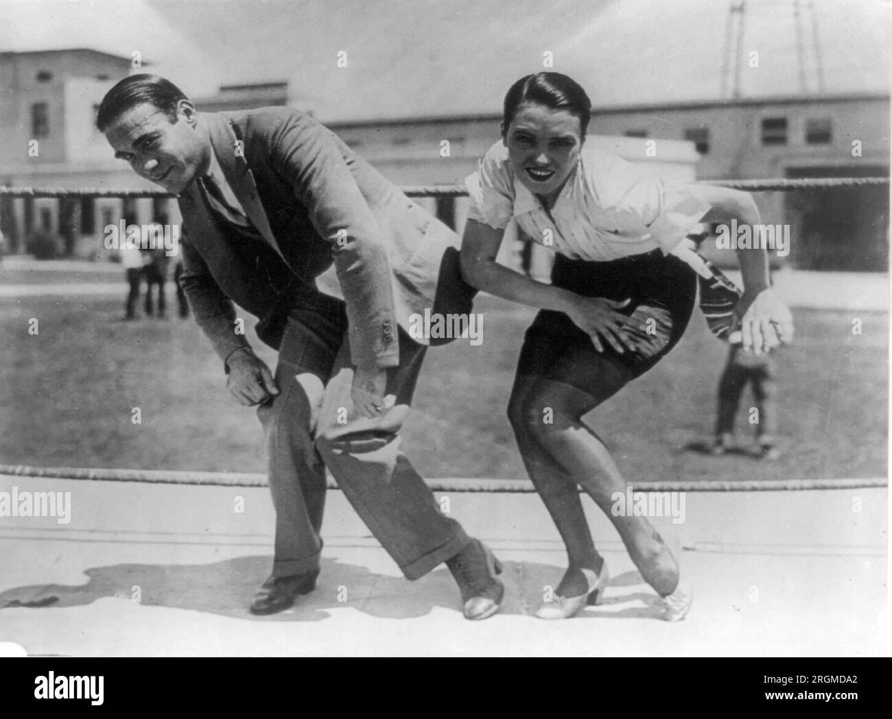 Frank Farnum coaching Pauline Starke. And now the Charleston is moving into the movies! Pauline Starke will introduce it to the movie public at large when in the role of a chorus girl in Metro-Goldwyn-Mayer's 'A Little bit of Broadway', she performs it on the screen. Frank Farnum, originator of the step, gave her first-hand (or foot) instructions ca. 1925 Stock Photo