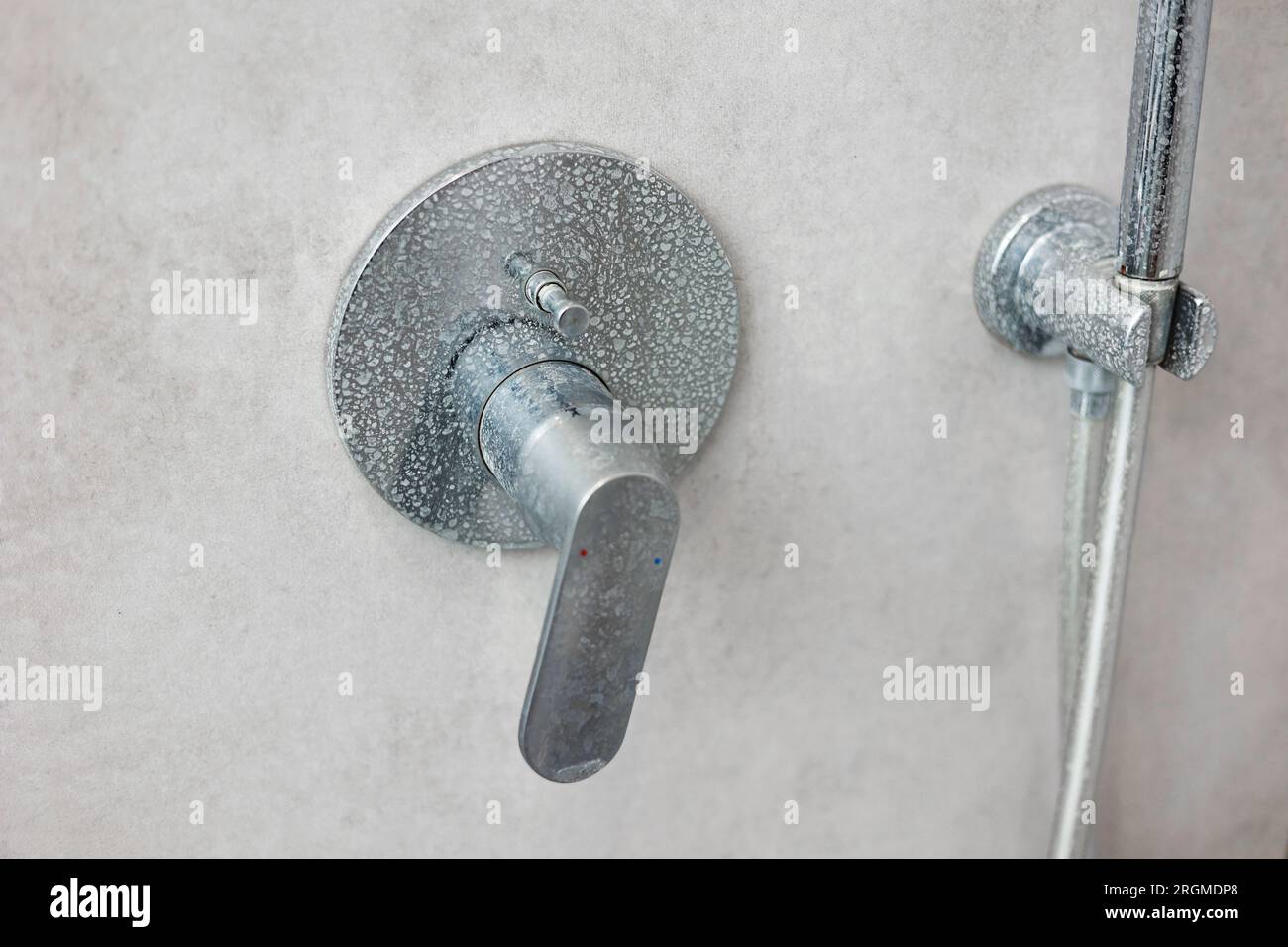Dirty calcified shower mixer tap, faucet with limescale on it, plaque
