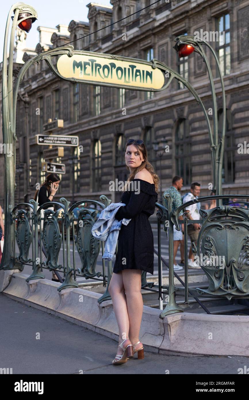 Paris, France. 10th Aug, 2023. A woman waits at a parisian metro entrance, Louvre museum and rivoli area in Paris, during the summer on August 10, 2023. Photo by Raphael Lafargue/ABACAPRESS.COM Credit: Abaca Press/Alamy Live News Stock Photo