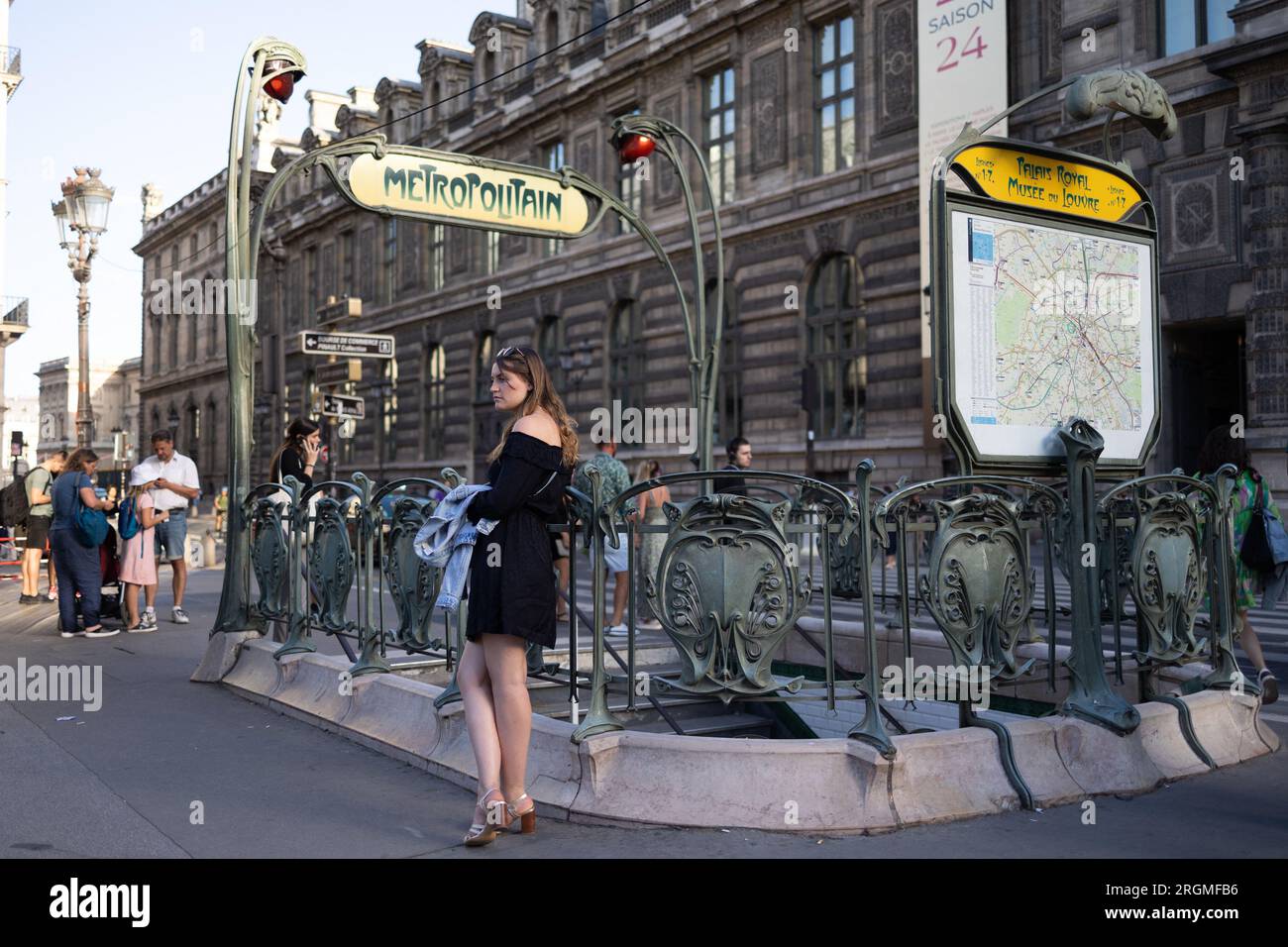 Paris, France. 10th Aug, 2023. A woman waits at a parisian metro entrance, Louvre museum and rivoli area in Paris, during the summer on August 10, 2023. Photo by Raphael Lafargue/ABACAPRESS.COM Credit: Abaca Press/Alamy Live News Stock Photo