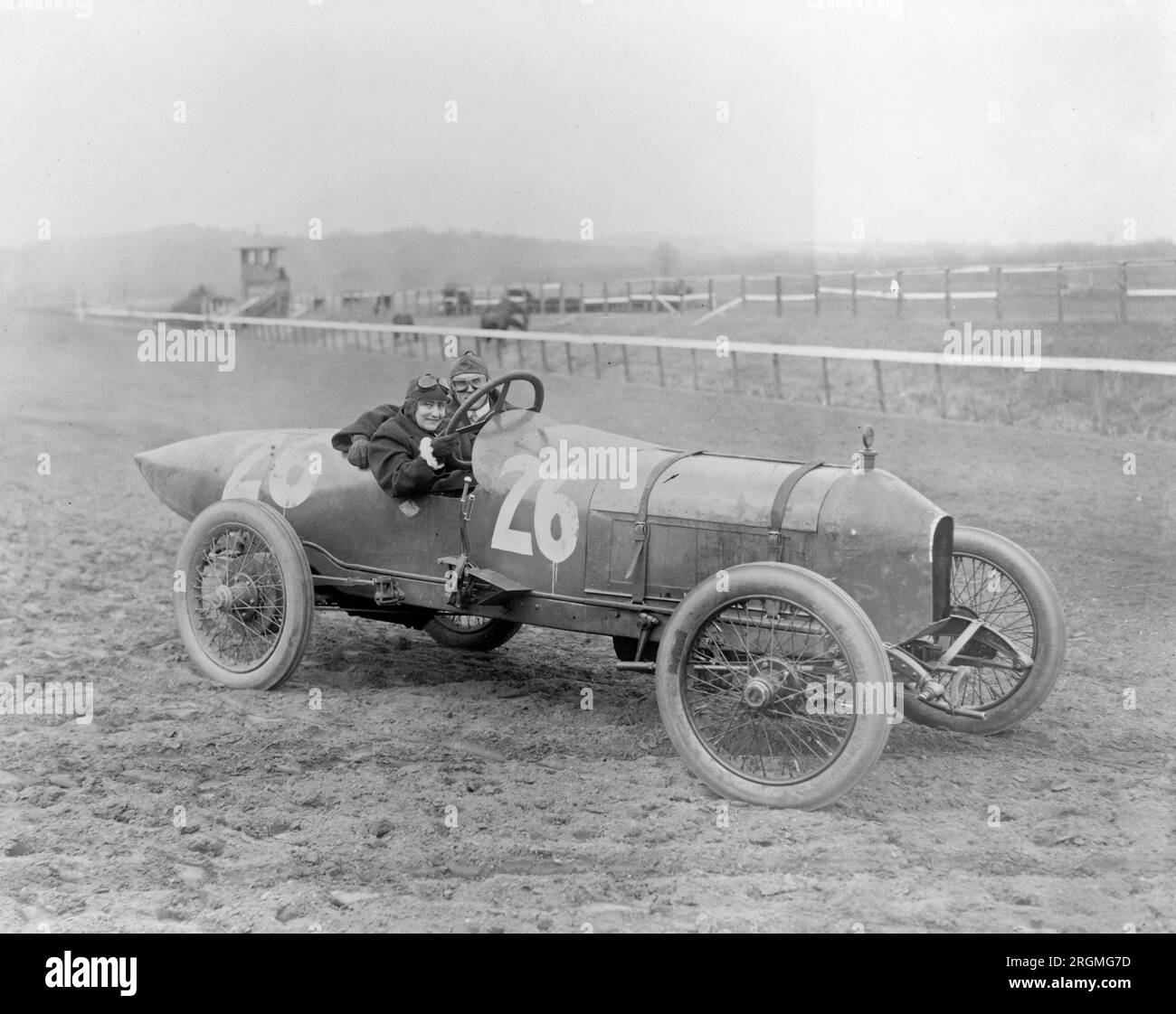 Vintage Auto Racing Side view of man and woman in Stutz Weightman
