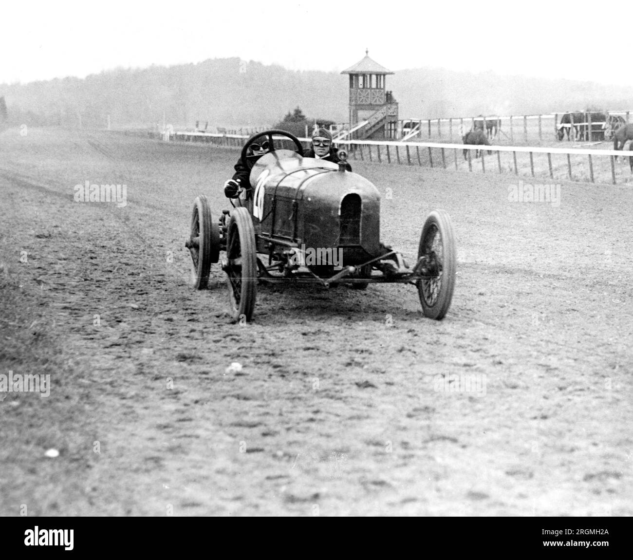 Vintage Auto Racing Front view of man and woman riding in Stutz